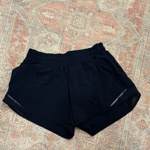 Navy Lululemon hotty hot 4” inseam.
regular rise